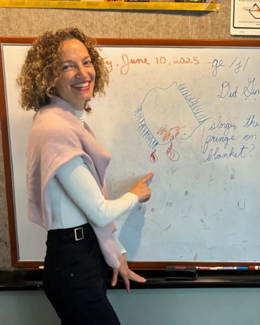 Sheridan Hotung teaching using a whiteboard